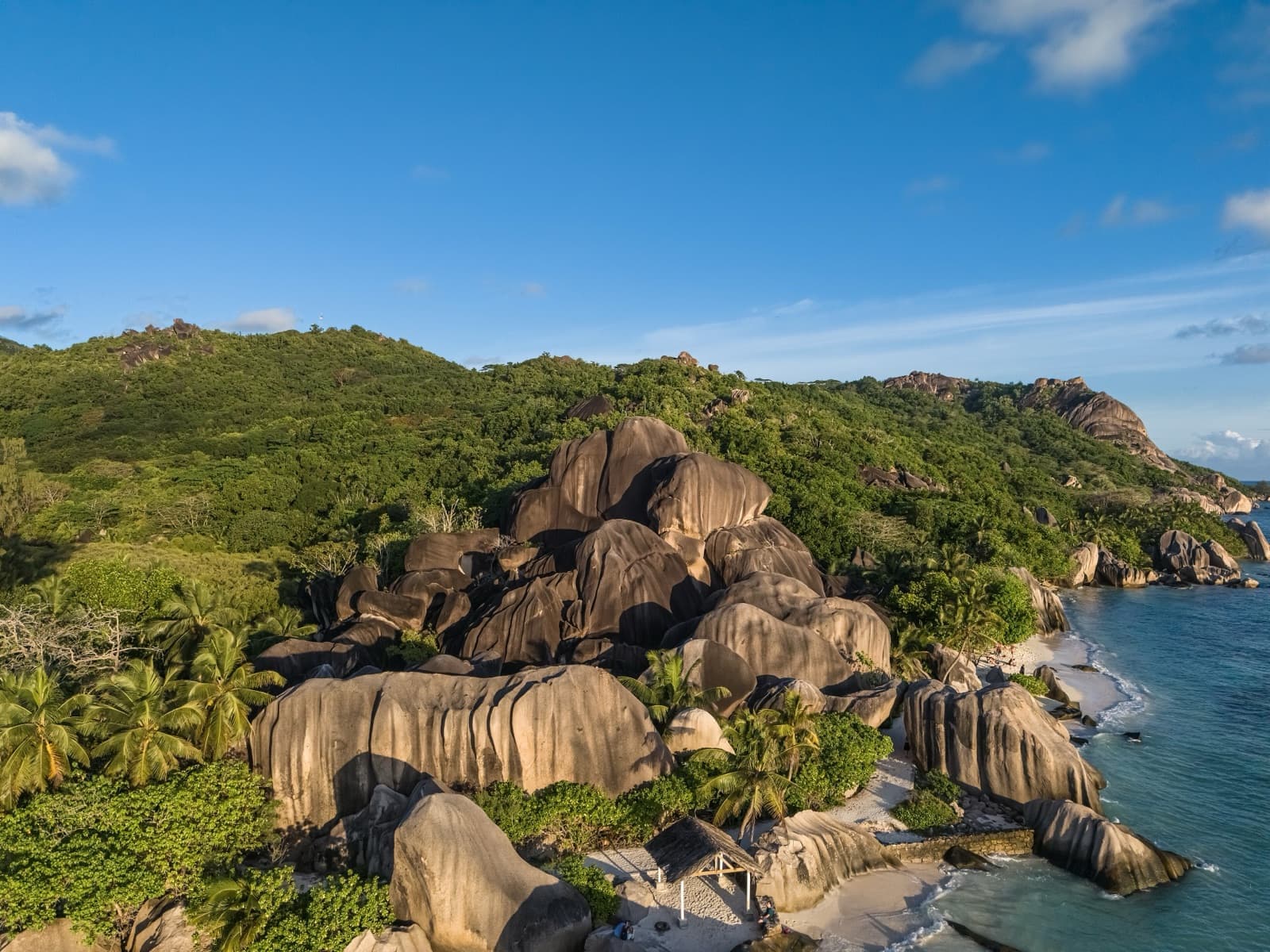 Rochers de granit, cocotiers et eaux turquoise sur une plage des Seychelles